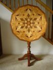 Photo of tilt-top table in the Parquetry style crafted by Isaac Leonard Wise 1934. Photo taken by grandson of craftsman, Richard Walter.